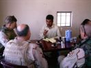 BC,MAJ Jones and Terp having tea with a Local national 2.JPG