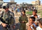 Sgt Biagi enjoys being swarmed by kids during a visit to their Area of Operations in NE Mosul.jpg