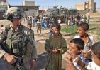 Sgt Biagi enjoys being swarmed by kids during a visit to their Area of Operations in NE Mosul~0.jpg